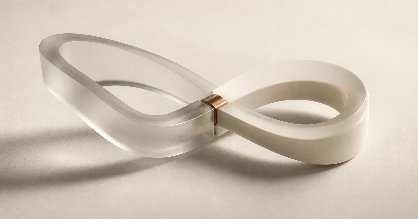 A translucent and ivory loop joined by a small copper connector.